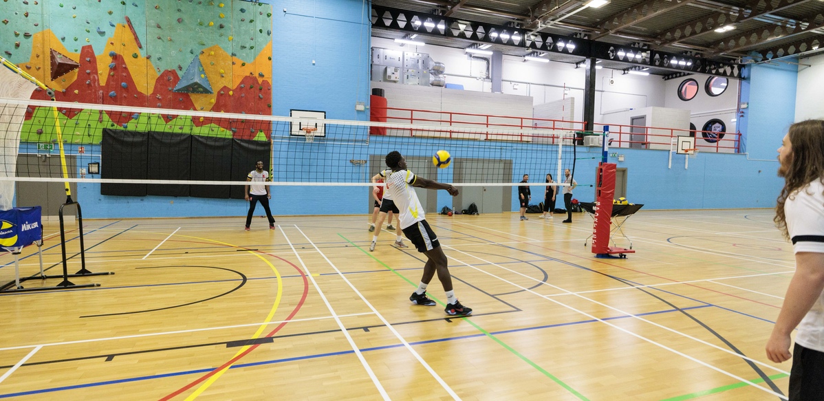 Students playing volley ball in the sports hall