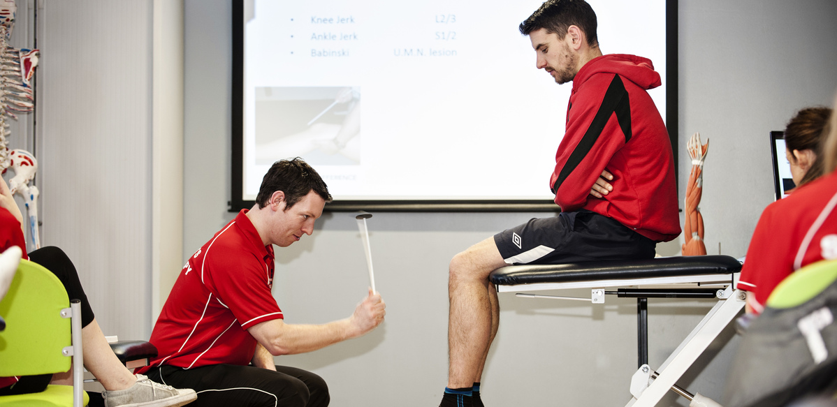 Demonstration of a neurological examination for reflexes on the knee