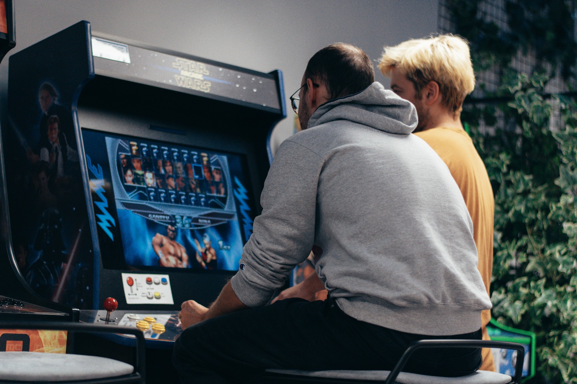 Students playing on one of Reload's retro arcade games machines.