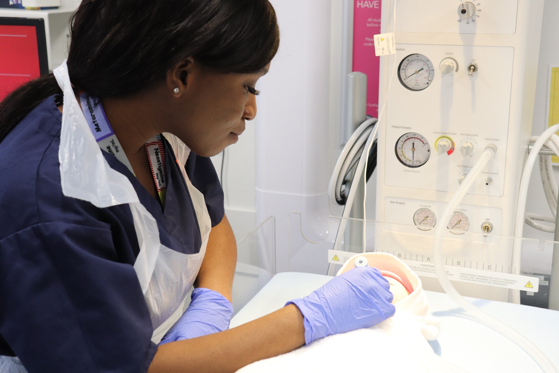 Close up of a student monitoring an infant manikin in the Resuscitaire.